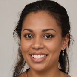 Joyful latino young-adult female with medium  brown hair and brown eyes