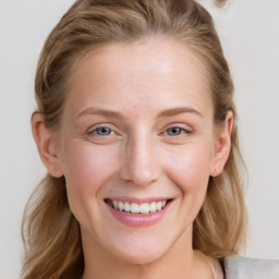 Joyful white young-adult female with long  brown hair and blue eyes