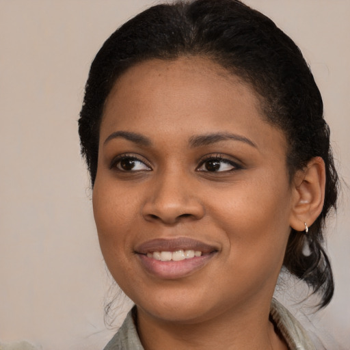 Joyful black young-adult female with medium  black hair and brown eyes