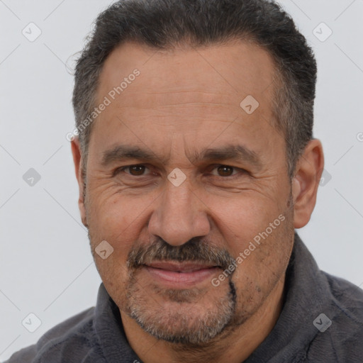 Joyful white middle-aged male with short  brown hair and brown eyes