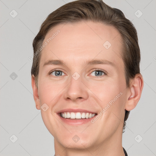 Joyful white young-adult male with short  brown hair and grey eyes