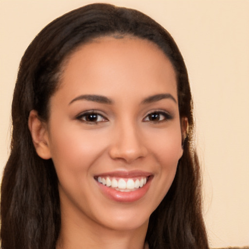 Joyful latino young-adult female with long  brown hair and brown eyes