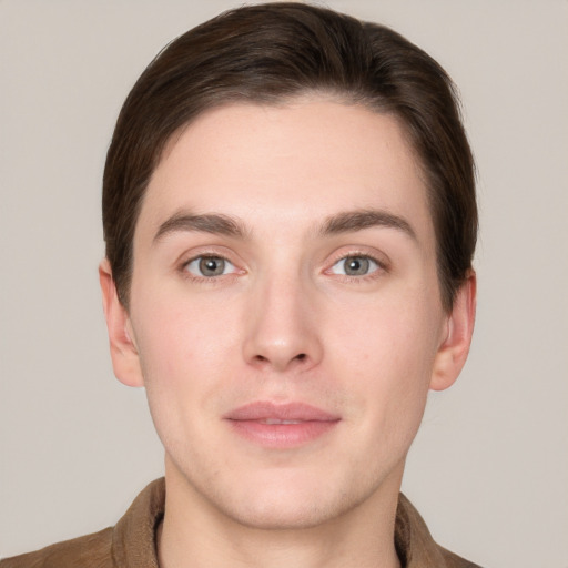 Joyful white young-adult male with short  brown hair and grey eyes