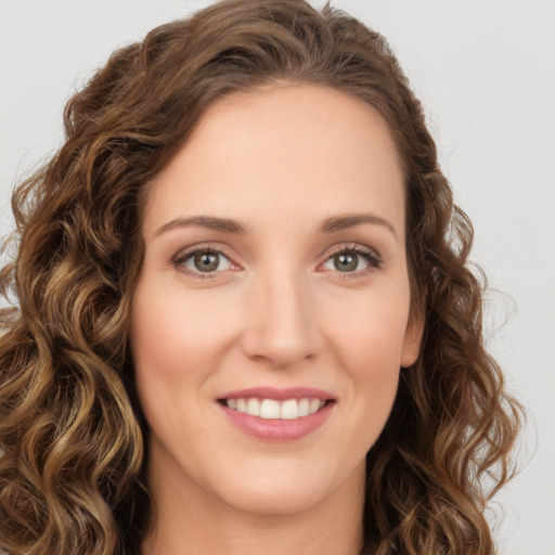 Joyful white young-adult female with long  brown hair and green eyes