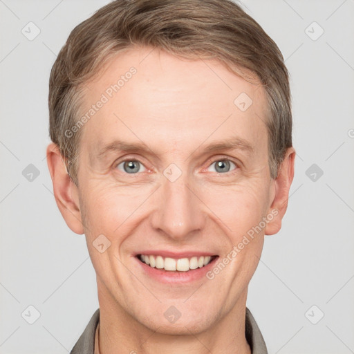 Joyful white adult male with short  brown hair and grey eyes