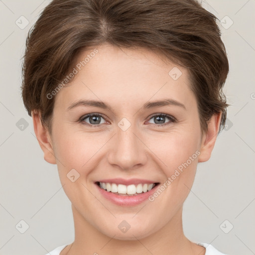 Joyful white young-adult female with short  brown hair and grey eyes