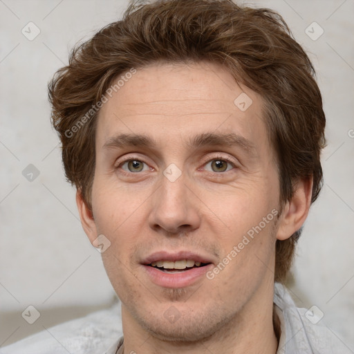 Joyful white adult male with short  brown hair and grey eyes