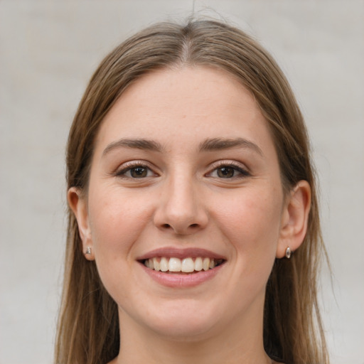 Joyful white young-adult female with long  brown hair and grey eyes