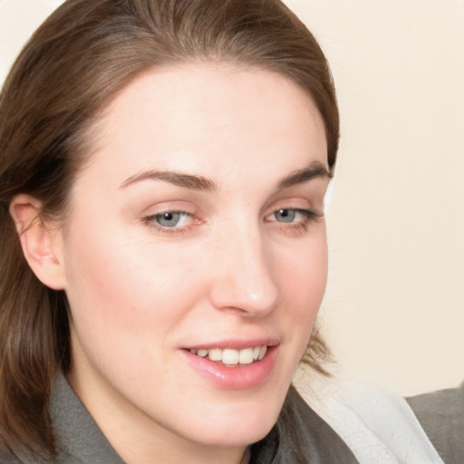 Joyful white young-adult female with medium  brown hair and blue eyes