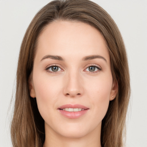 Joyful white young-adult female with long  brown hair and grey eyes