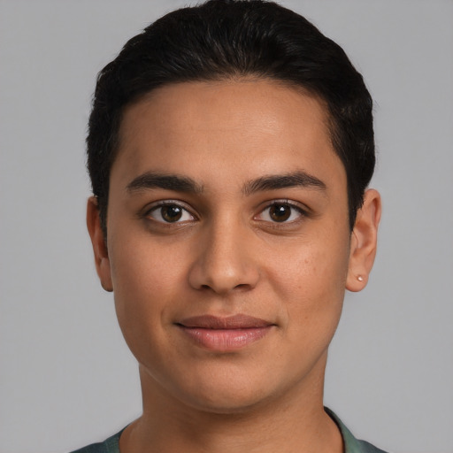 Joyful latino young-adult male with short  brown hair and brown eyes