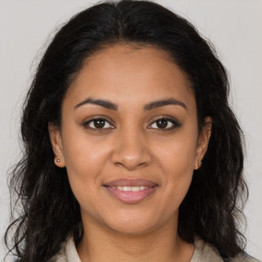 Joyful latino young-adult female with long  brown hair and brown eyes