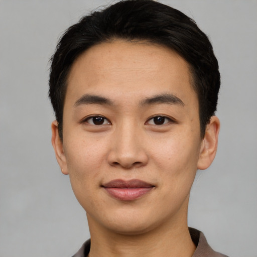 Joyful asian young-adult male with short  black hair and brown eyes