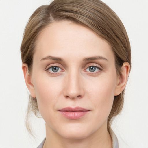 Joyful white young-adult female with medium  brown hair and blue eyes