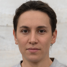 Joyful white young-adult female with short  brown hair and grey eyes