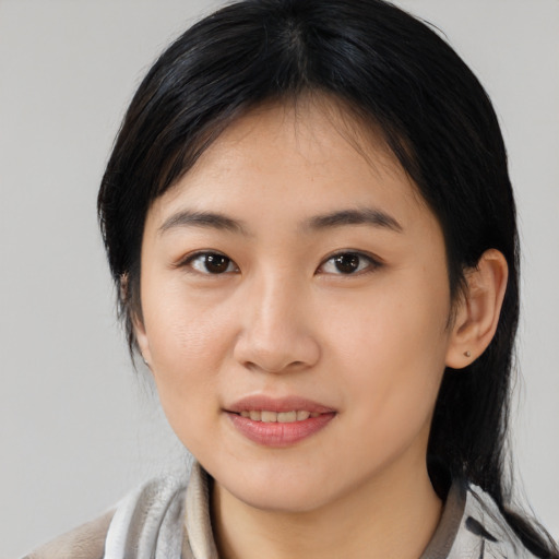 Joyful asian young-adult female with medium  black hair and brown eyes