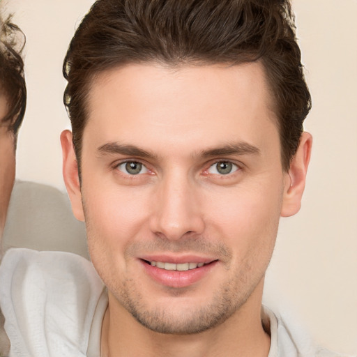 Joyful white young-adult male with short  brown hair and brown eyes