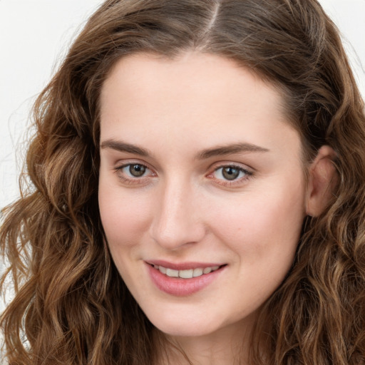 Joyful white young-adult female with long  brown hair and green eyes