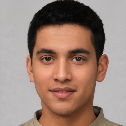 Joyful latino young-adult male with short  brown hair and brown eyes