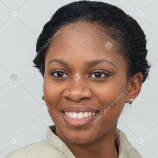 Joyful black young-adult female with short  black hair and brown eyes