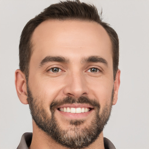 Joyful white young-adult male with short  brown hair and brown eyes