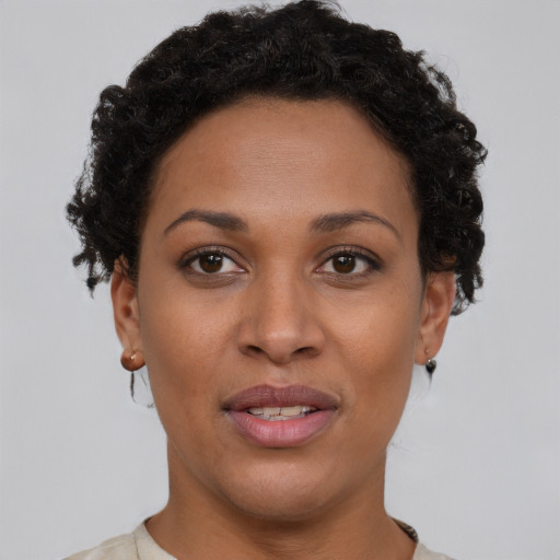 Joyful black young-adult female with short  brown hair and brown eyes