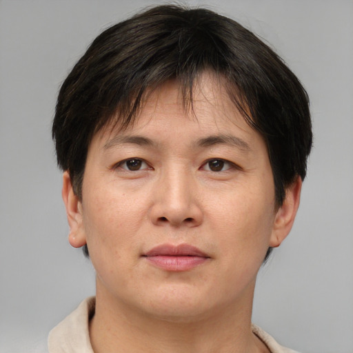 Joyful asian adult female with short  brown hair and brown eyes