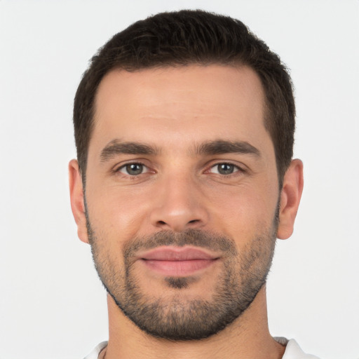 Joyful white young-adult male with short  brown hair and brown eyes