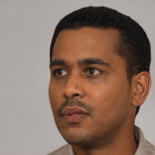 Neutral black young-adult male with short  black hair and brown eyes