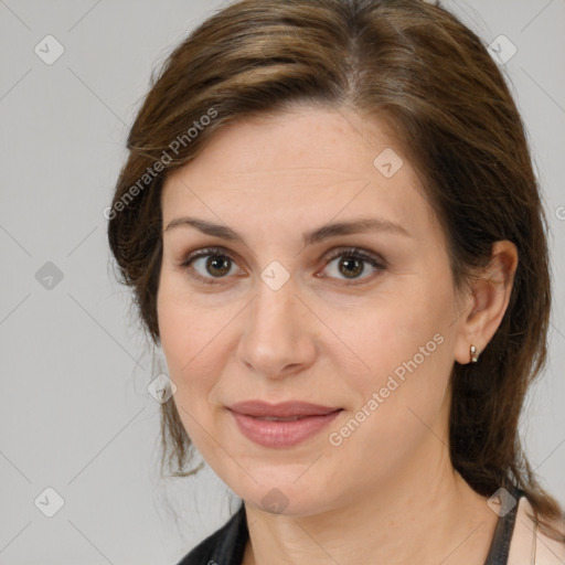 Joyful white adult female with medium  brown hair and brown eyes