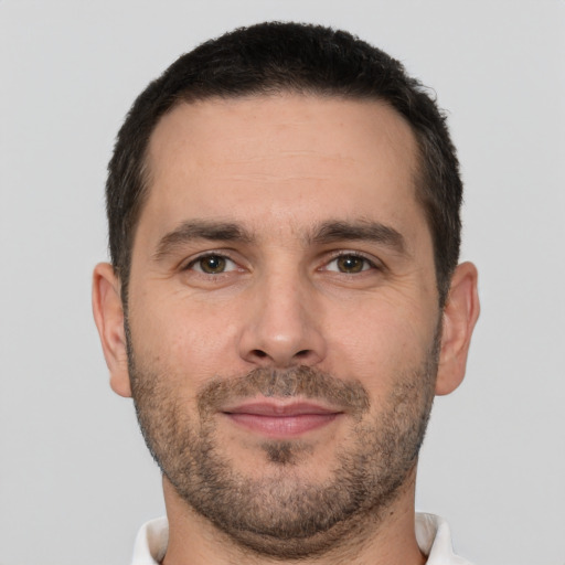 Joyful white adult male with short  brown hair and brown eyes