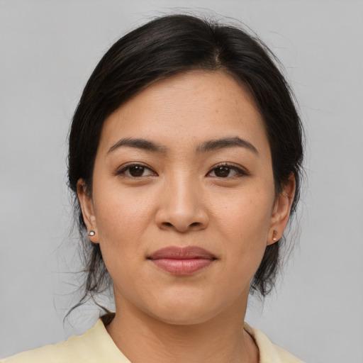 Joyful asian young-adult female with medium  brown hair and brown eyes