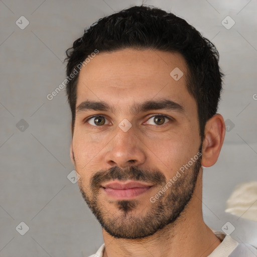 Joyful white young-adult male with short  black hair and brown eyes