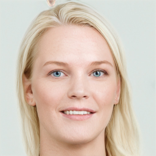 Joyful white young-adult female with long  brown hair and blue eyes