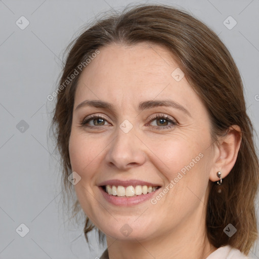 Joyful white adult female with medium  brown hair and brown eyes