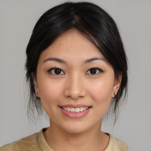 Joyful asian young-adult female with medium  brown hair and brown eyes