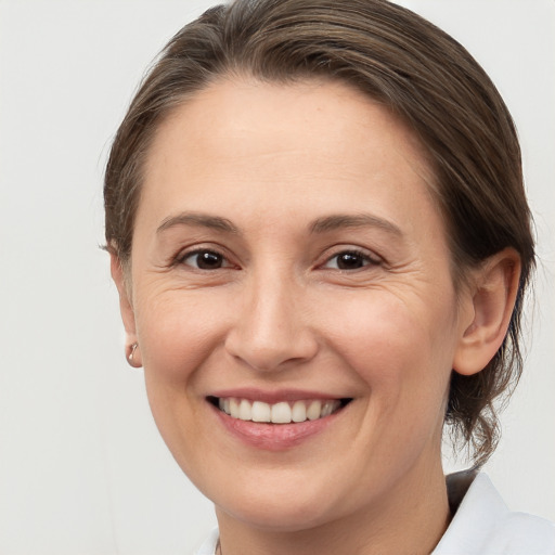 Joyful white adult female with medium  brown hair and brown eyes