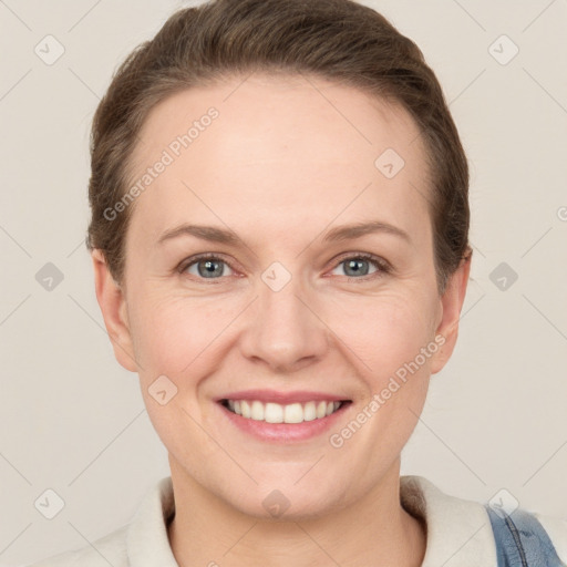 Joyful white adult female with short  brown hair and grey eyes