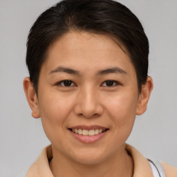 Joyful asian young-adult female with short  brown hair and brown eyes