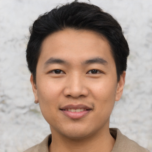 Joyful asian young-adult male with short  black hair and brown eyes