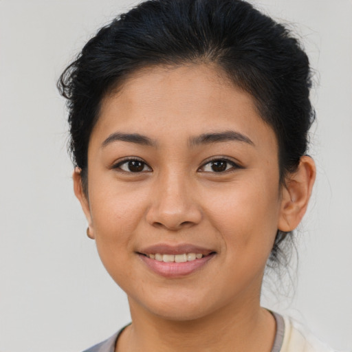 Joyful latino young-adult female with short  brown hair and brown eyes