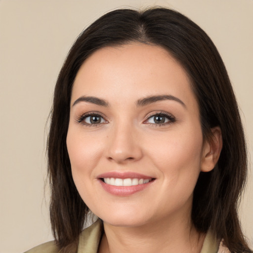 Joyful white young-adult female with long  brown hair and brown eyes