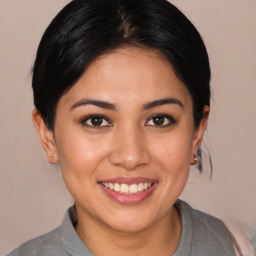 Joyful white young-adult female with medium  brown hair and brown eyes