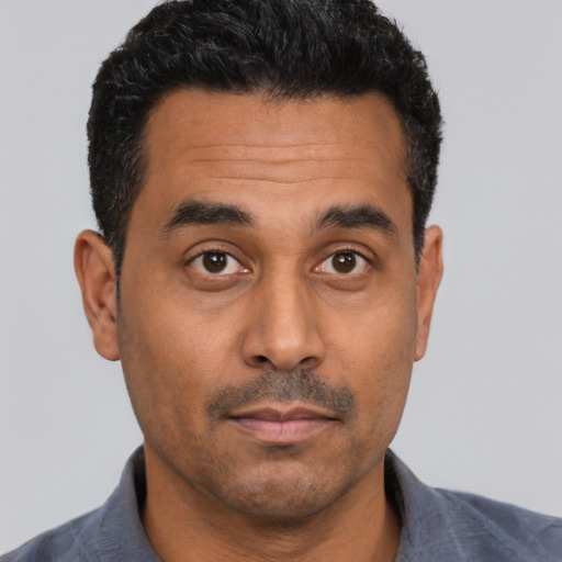 Neutral latino adult male with short  black hair and brown eyes