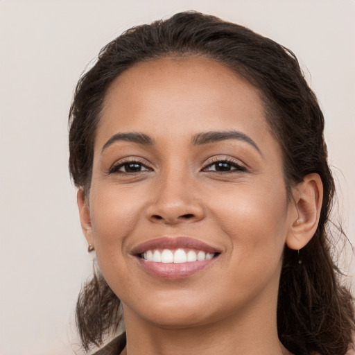 Joyful white young-adult female with long  brown hair and brown eyes