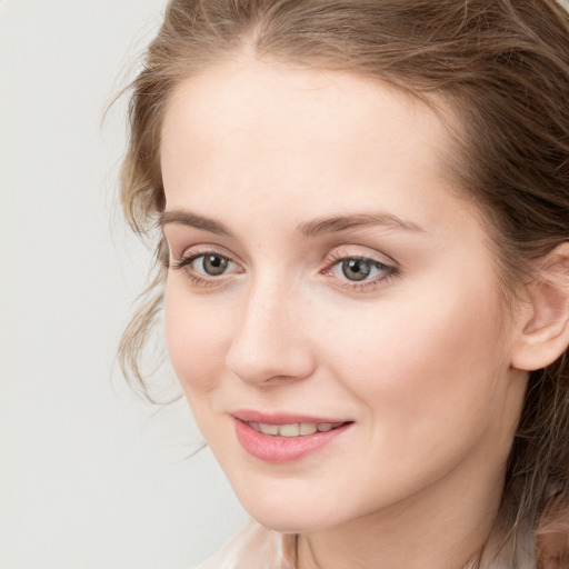 Joyful white young-adult female with long  brown hair and blue eyes