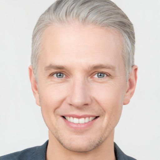 Joyful white adult male with short  brown hair and grey eyes