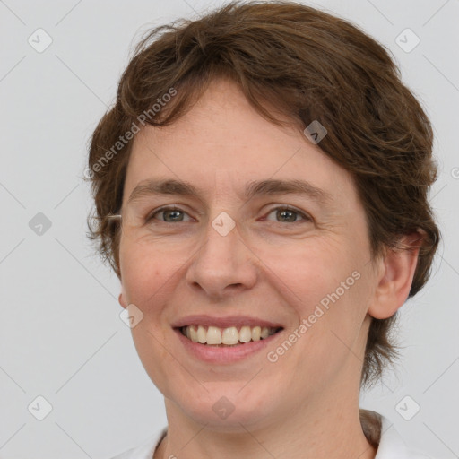 Joyful white adult female with medium  brown hair and grey eyes