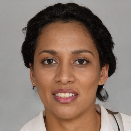 Joyful black adult female with short  black hair and brown eyes