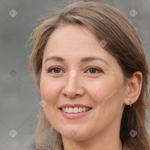 Joyful white adult female with long  brown hair and brown eyes